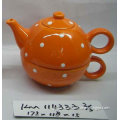 orange ceramic tea pot with cup
